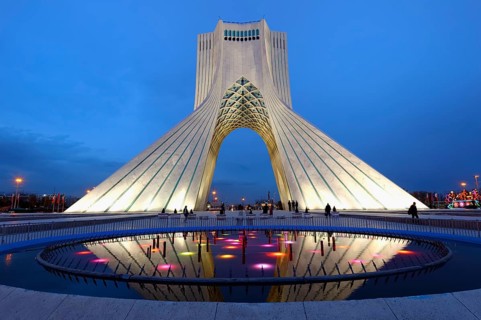 Illuminated Azadi Tower at blue hour