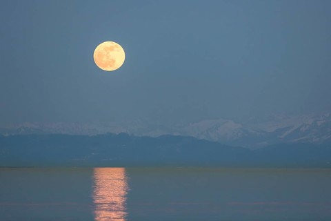 Full moon rising over Lake Constance and Mount Pfaender