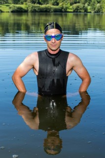 Triathlete standing in Aichstruter Reservoir