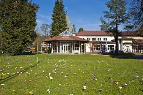 Historic Kurhaus with a pavilion and crocuses in the lawn