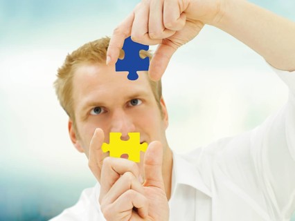 Man putting pieces of a jigsaw puzzle together