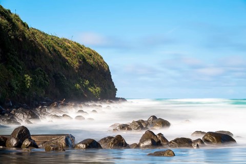 Surf washing over rocks on the beach
