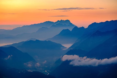 Blue mountain silhouettes at sunrise