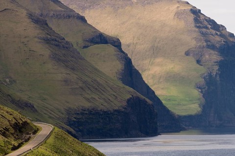 Road and mountains towering from the sea