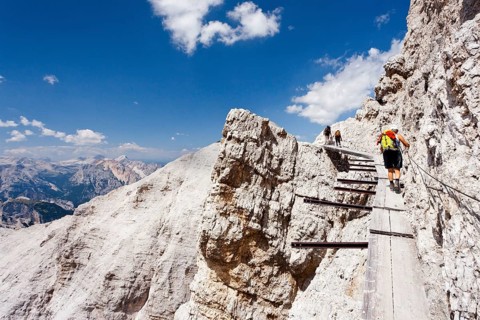 Climber climbing along the Via Ferrata Ivano Dibona climbing route on Monte Cristallo to the summit of Cristallino