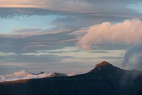 Mountain landscape in the evening light with a cloudy sky