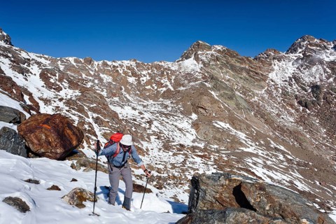 Hiker during the ascent of Hintere Eggenspitze Mountain in the Ulten Valley