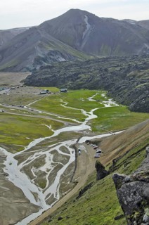 View over the Laugahraun lava field with cabins and a camping site