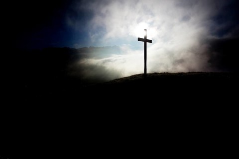 Summit cross of Gerenberg Mountain with high fog in front of the Alpstein Mountains