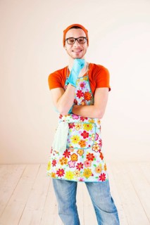 Young man wearing an apron and cleaning gloves