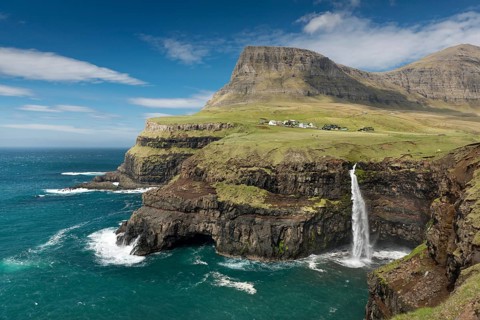 Waterfall on the cliffs near a village