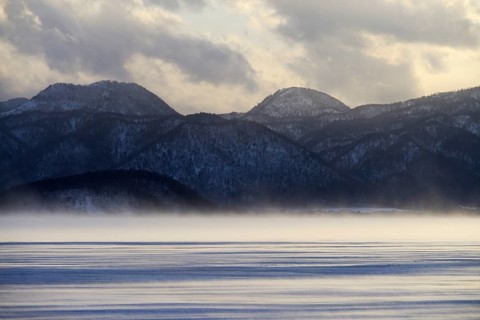 Fog over the frozen Lake Kussharo