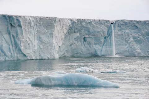 Waterfall of meltwater at the glacier front of Brasvellbreen