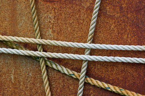 Taut ropes on a rusty surface