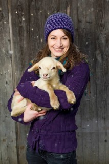 Woman holding a lamb in her arms
