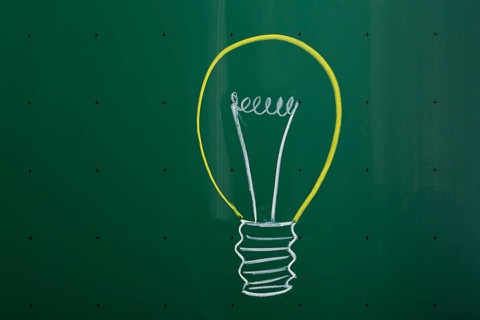 Light bulb drawn with chalk on a blackboard