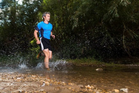 Jogger running through a stream