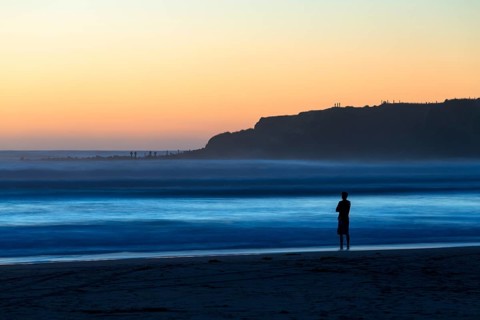 Man on the beach with surf