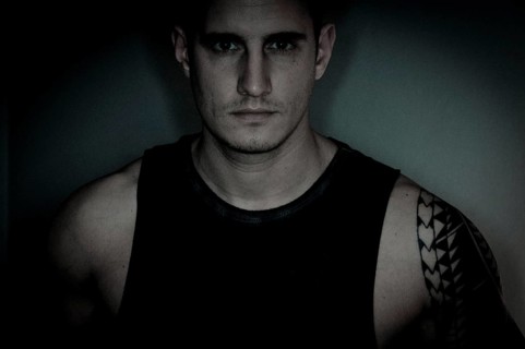 Young man with tattooed arm in singlet