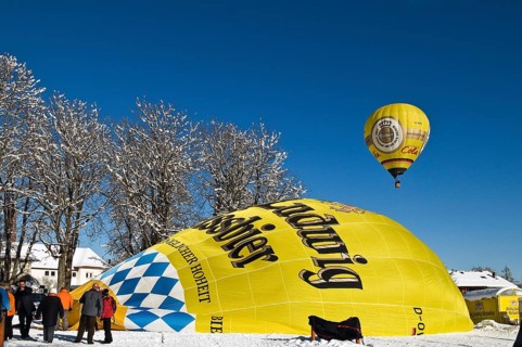 Balloons in the air or balloon envelope being inflated on the ground