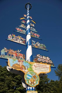 May pole on Viktualienmarkt square with the explanation of the Munich Beer Purity Law of 1487