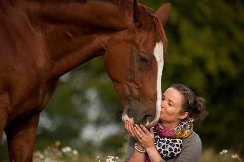 Woman kissing a Hanoverian horse