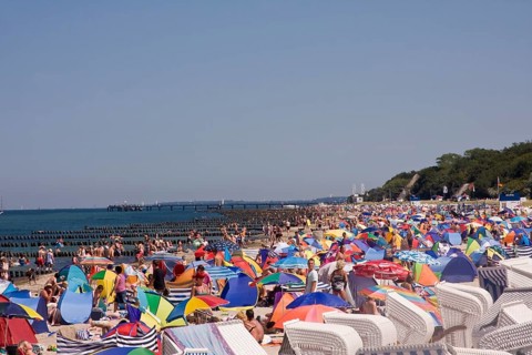 Roofed wicker beach chairs on a beach
