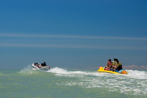 Tourists being pulled on a banana boat ride