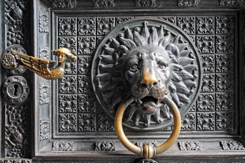 Lion head door knocker on the entrance portal