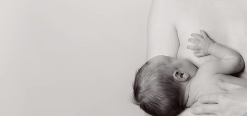 Woman breastfeeding a boy