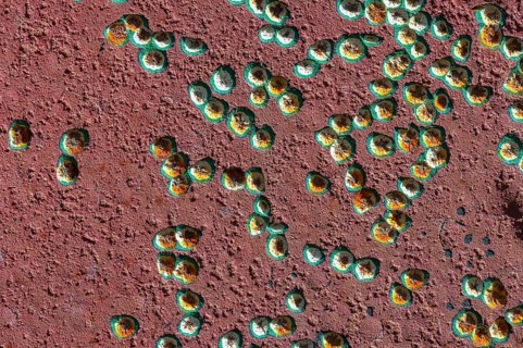 Painted surface with small coloured dents