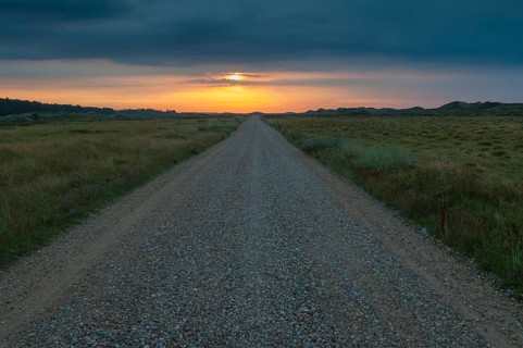 Morning mood over a gravel road through heathland