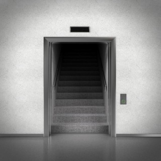 Open elevator doors revealing stairs behind them