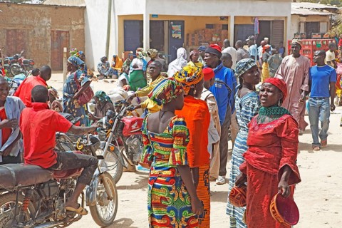 Woman selling typical gourd helmets at a market