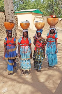 Fulani women carrying milk calabashes on their heads