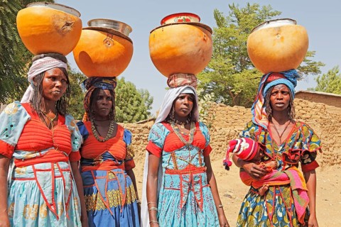 Fulani women carrying milk calabashes on their heads