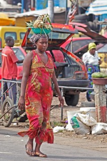 Market woman carrying pineapple on her head