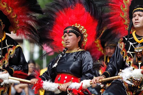 Woman and man wearing festive traditional Indio costumes