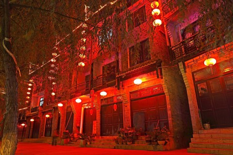 Red illuminated row of houses at night