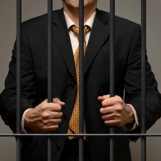 Jailed business man behind prison bars