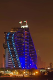 The illuminated Jumeirah Beach Hotel on Jumeirah beach at dusk