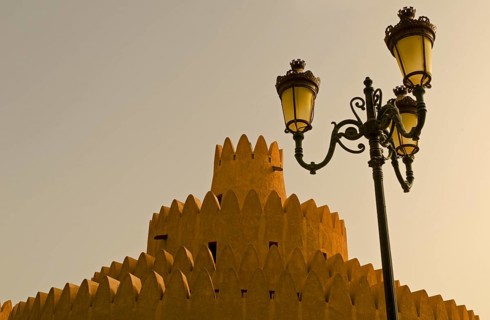 A tower of the Al Ain Palace Museum or Sheikh Zayed Palace Museum and a street lamp