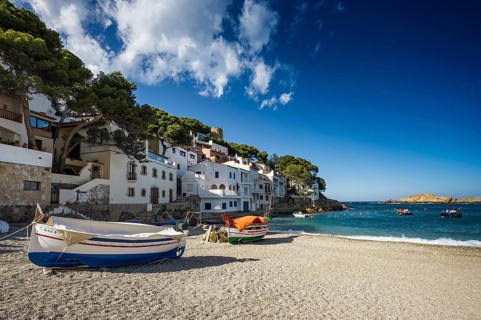Village with beach and fishing boats on the sea