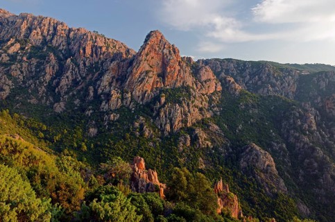 The typical bizarre red rocks of the Calanche of Pianasurrounded by green scrub. The Calanche of Piana is in the western part of the island Corsica