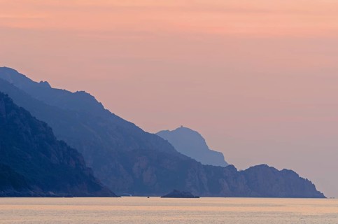 The Gulf of Porto with the surrounding mountains at sunset