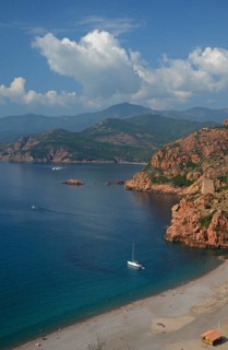 The Genoese Tower of Porto on top of a rocky hill and the Gulf of Porto