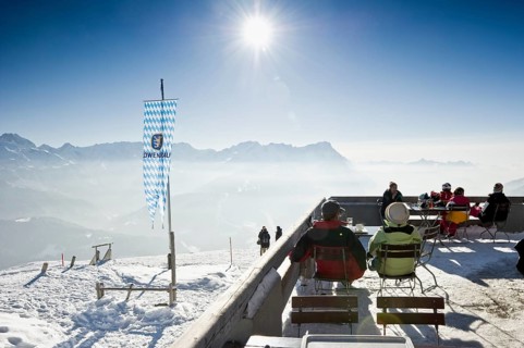 Mountain inn with a winter landscape and the sun