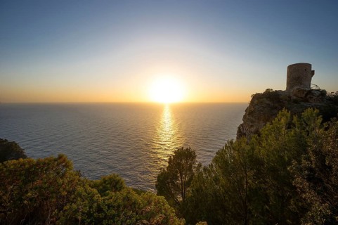 Old watchtower on the coast at sunset