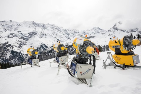 Snow cannon and snow-covered mountains
