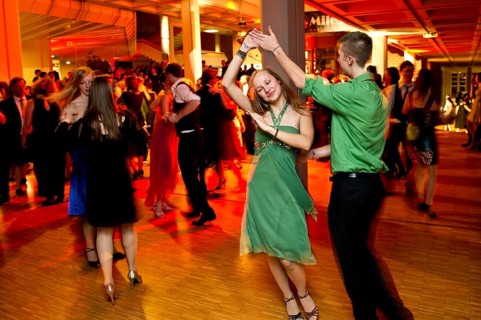 Young couple dancing at the prom of a dance school